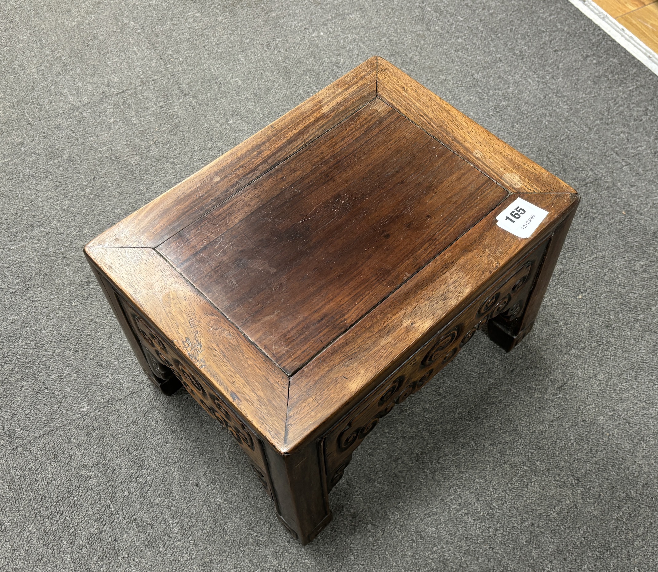 A Chinese low rectangular hardwood stand carved with scrolls, width 37cm, depth 28cm, height 26cm